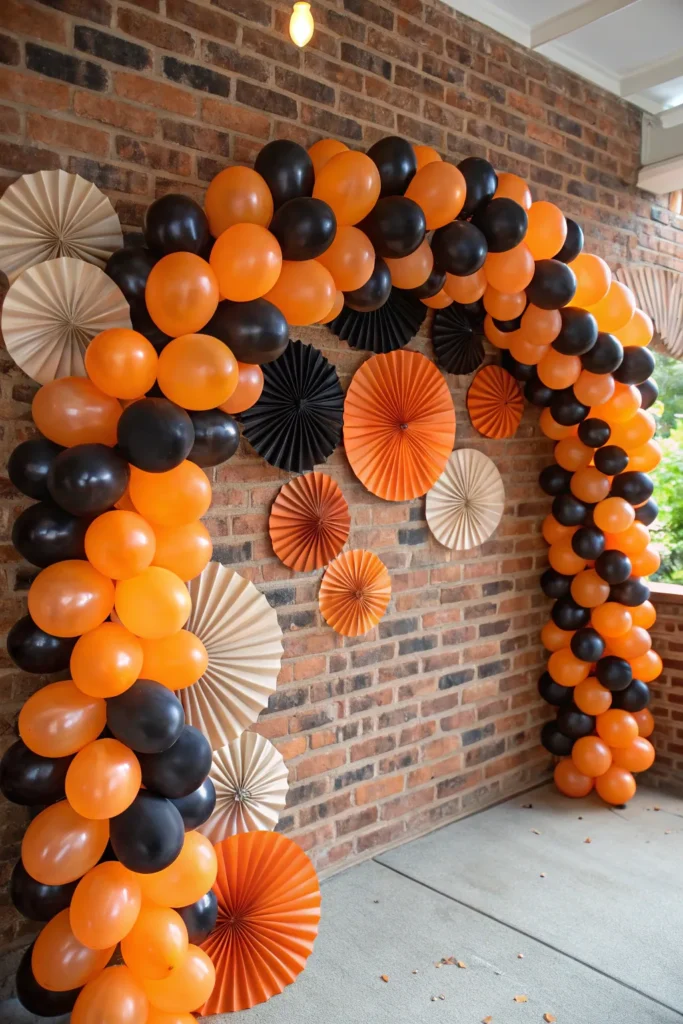 6 orange and black balloon arch with paper fans